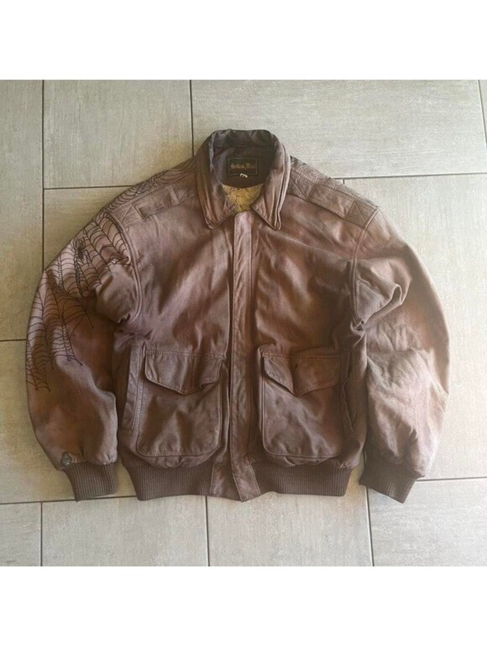 Brown vintage leather British mist jacket with castle, dragon, and spiderweb art